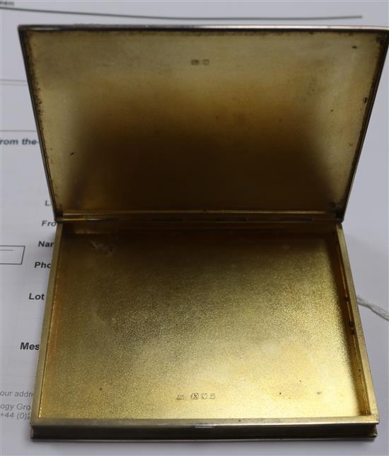 Two silver compacts and two engine turned silver cigarette cases including one modelled as a book.